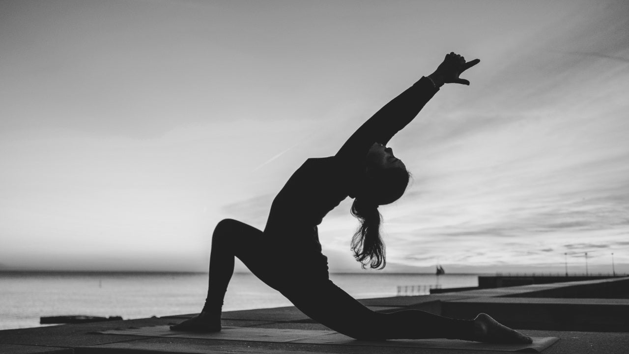 woman doing a daily yoga and stretching routine for overall wellness