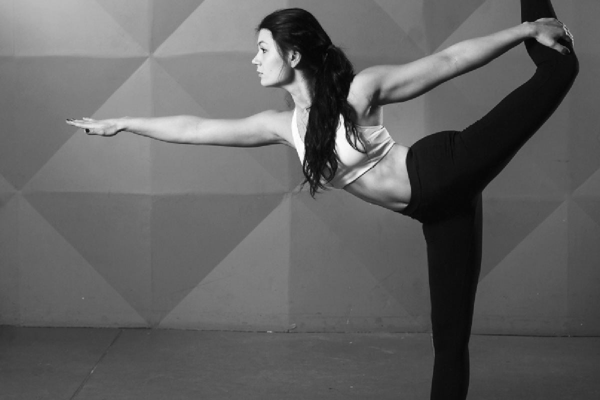 woman stretching - example of what helps with plantar fasciitis