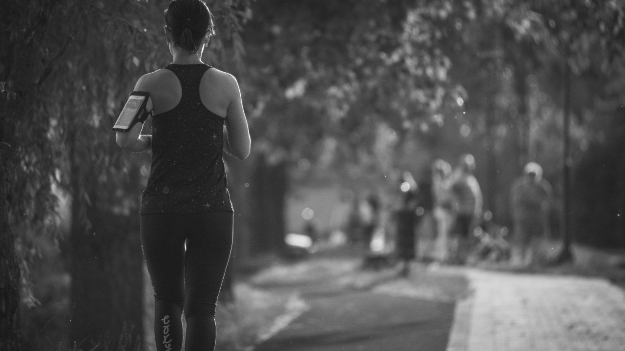 woman running while wearing slip-on shoes