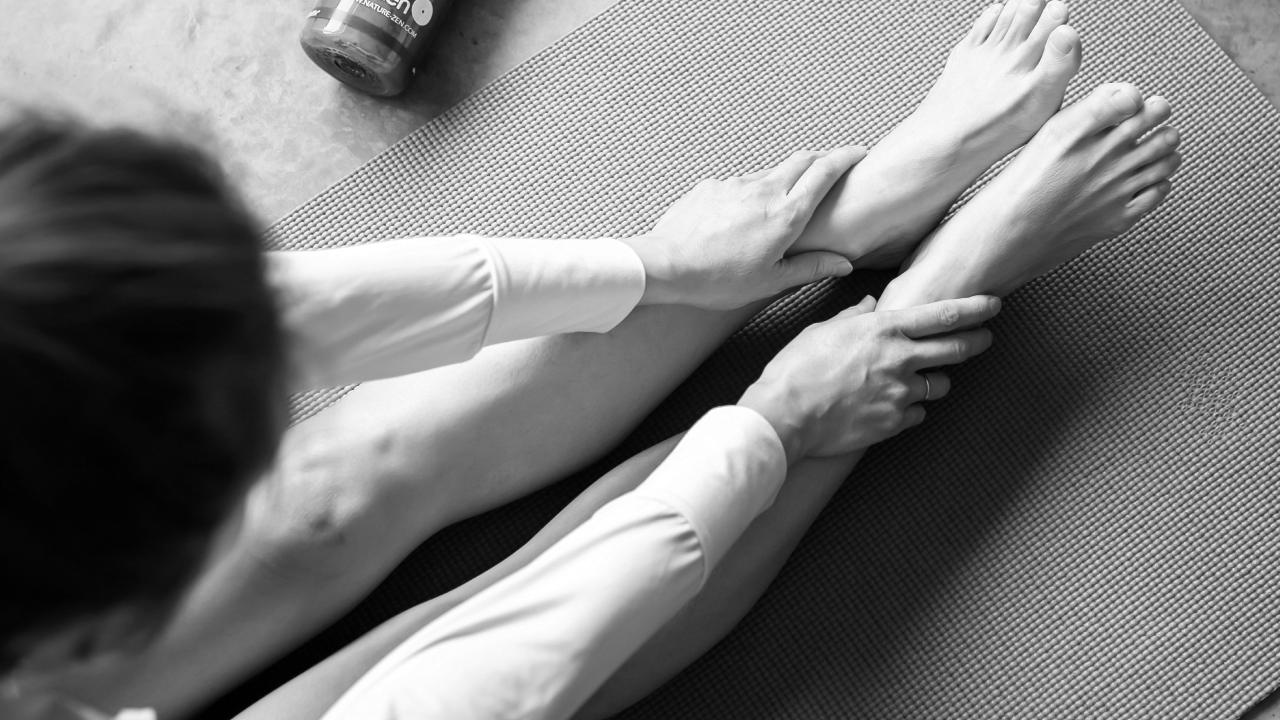 person stretching for heel pain