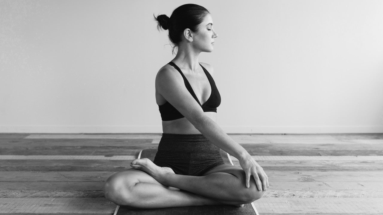 woman stretching and wondering about different types of foot pain