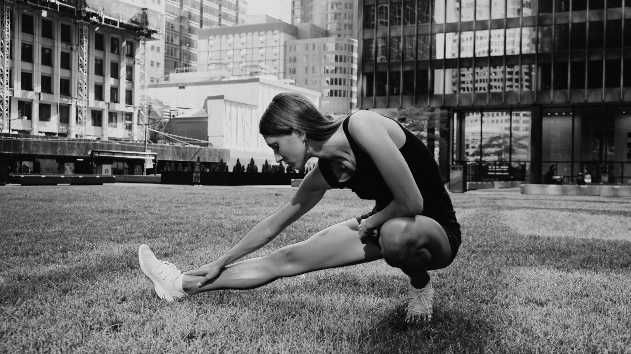 person stretching to relieve ball of foot pain