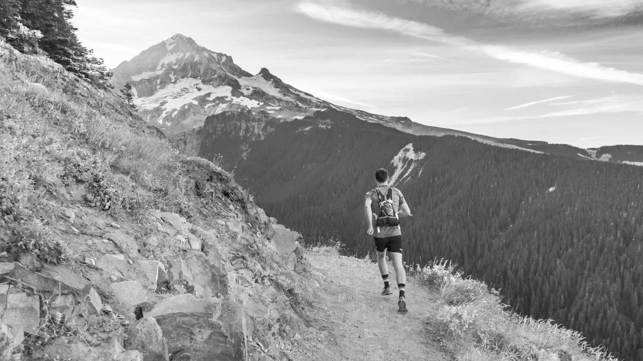 person with strong foot arches running on a mountainside trail