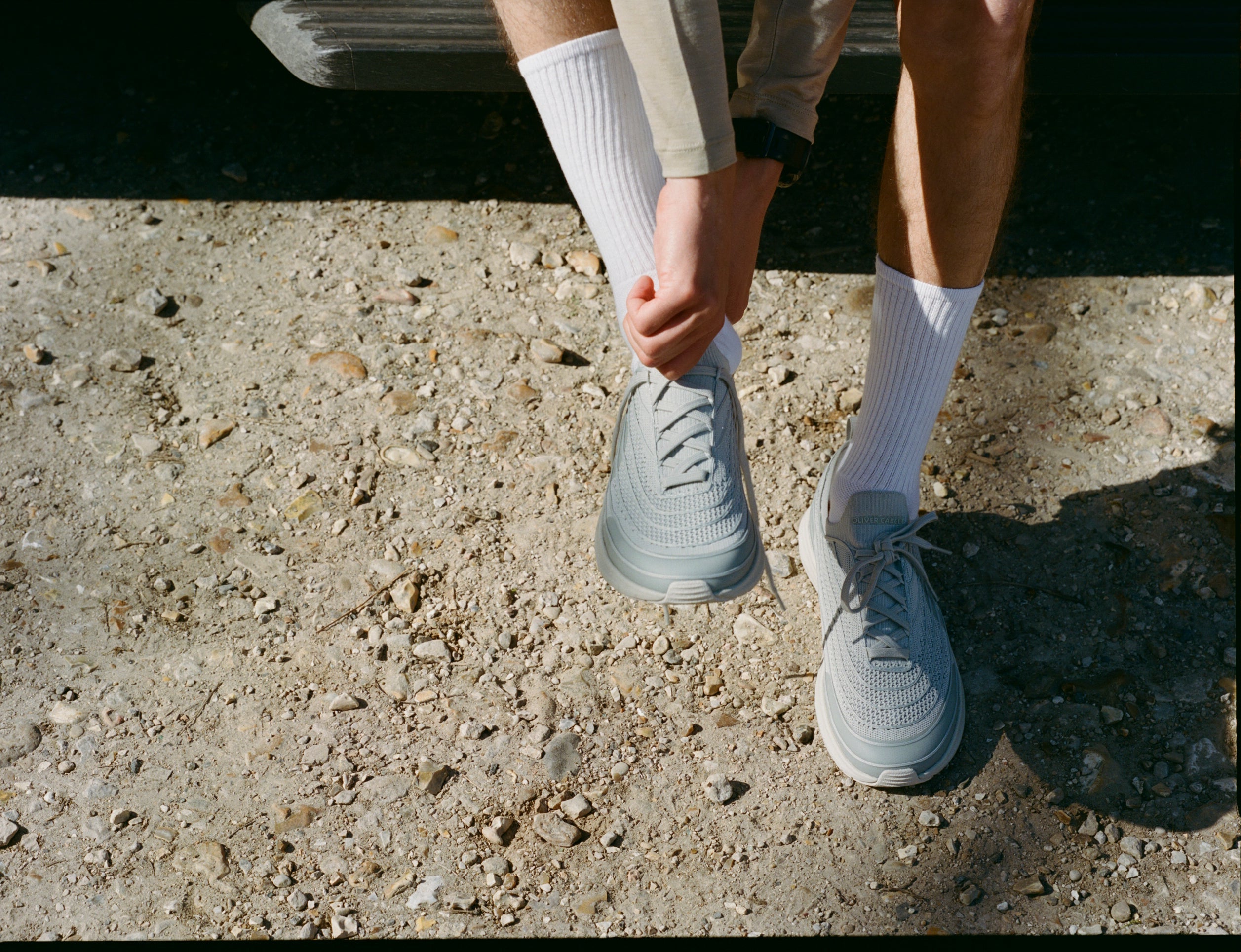 person putting on wide toe box shoes